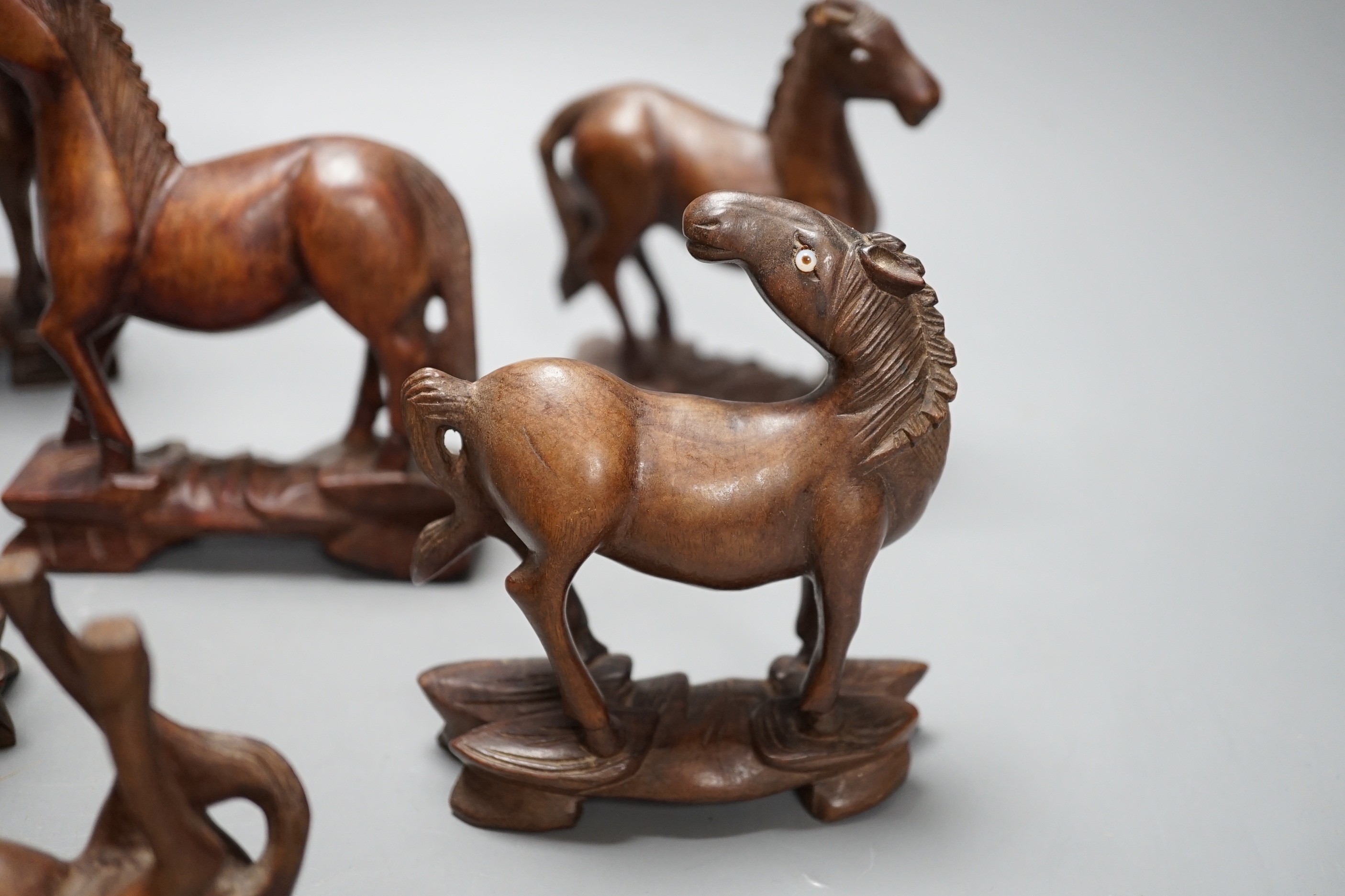 Seven Chinese hardwood models of horses. Tallest 13cm